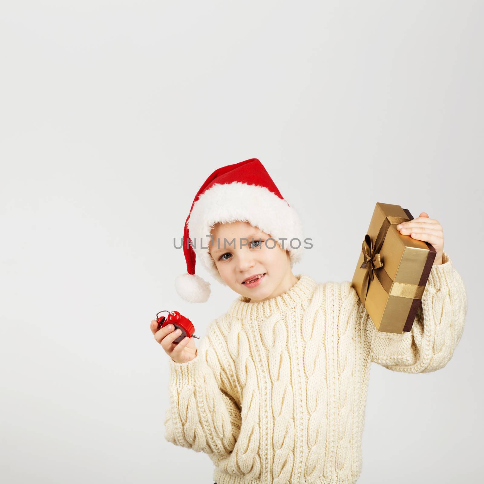Portrait of happy joyful beautiful little boy wearing Santa hat against white background. New Year and Christmas concept