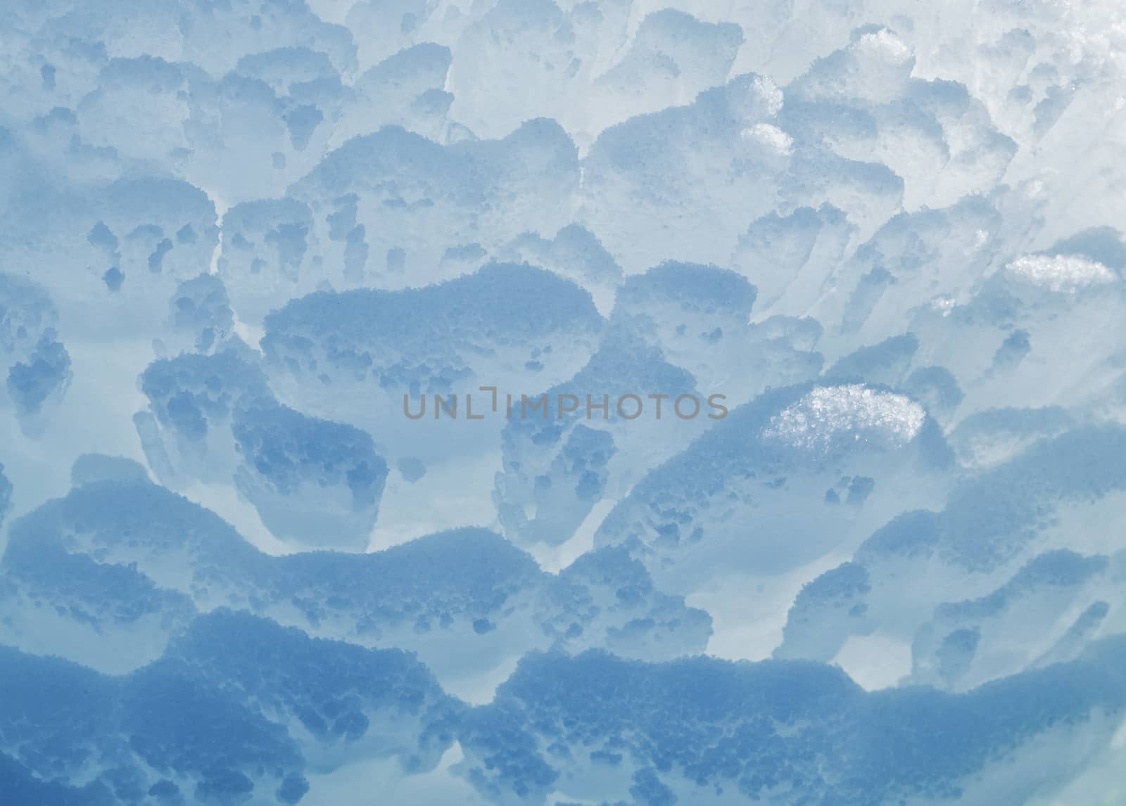 Block of blue smooth melting ice, close-up