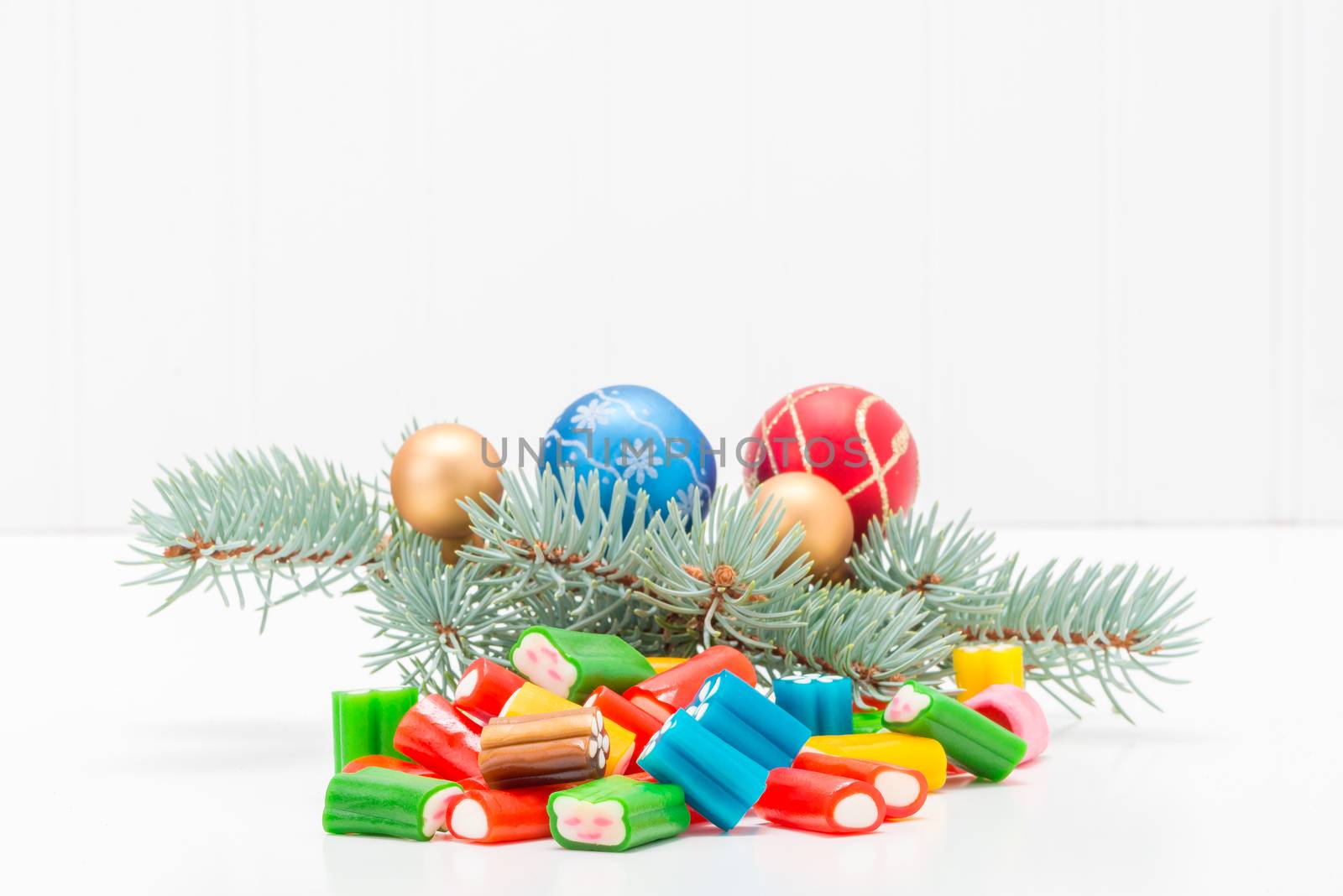 Colorful array of mixed candy with a festive seasonal background.