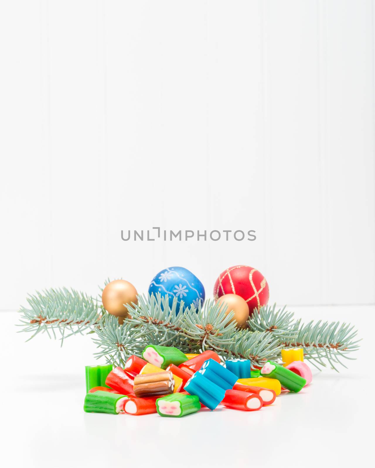 Colorful array of holiday candy in a festive seasonal background.
