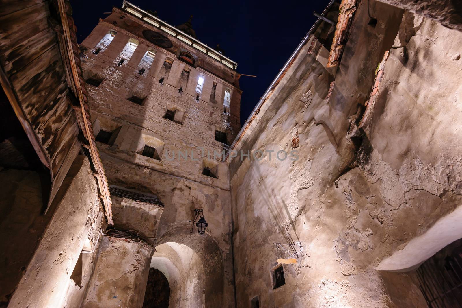 View to the watch tower at night in Sighisoara town, Romania