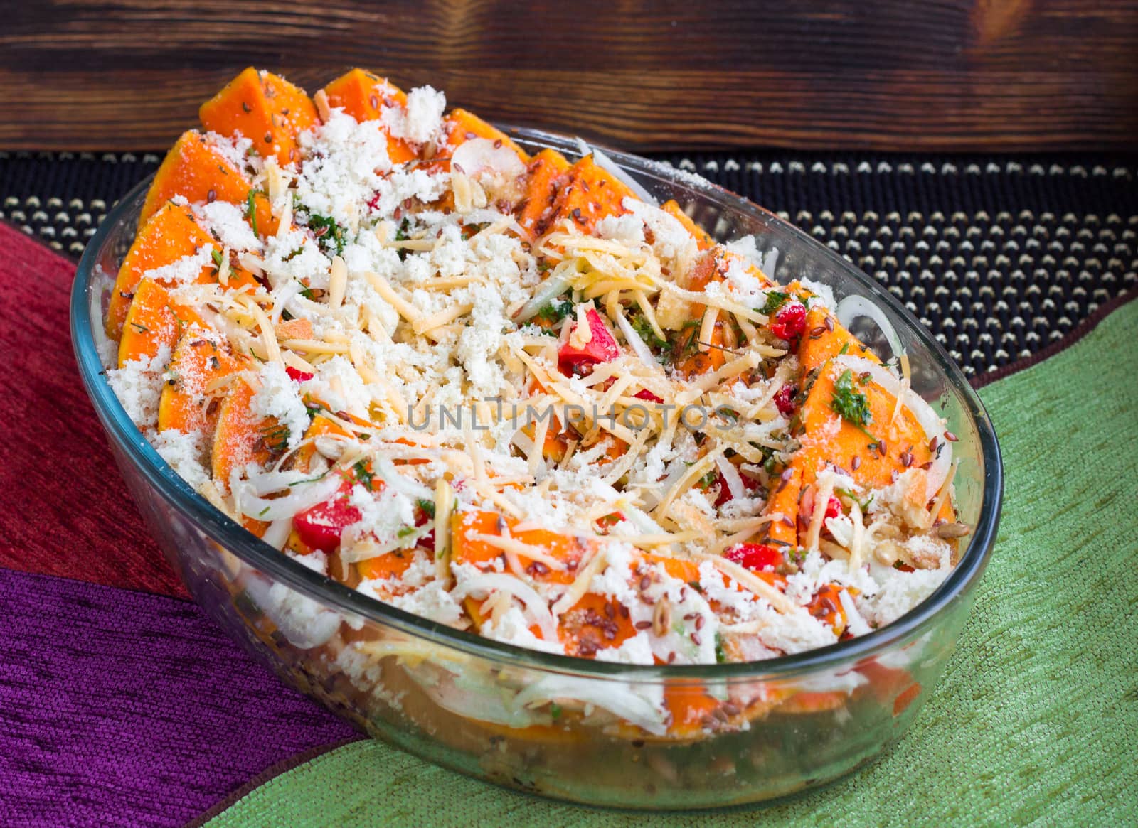 Vegetarian salad of orange pumkin, mixed vegetables, herbs and cheese