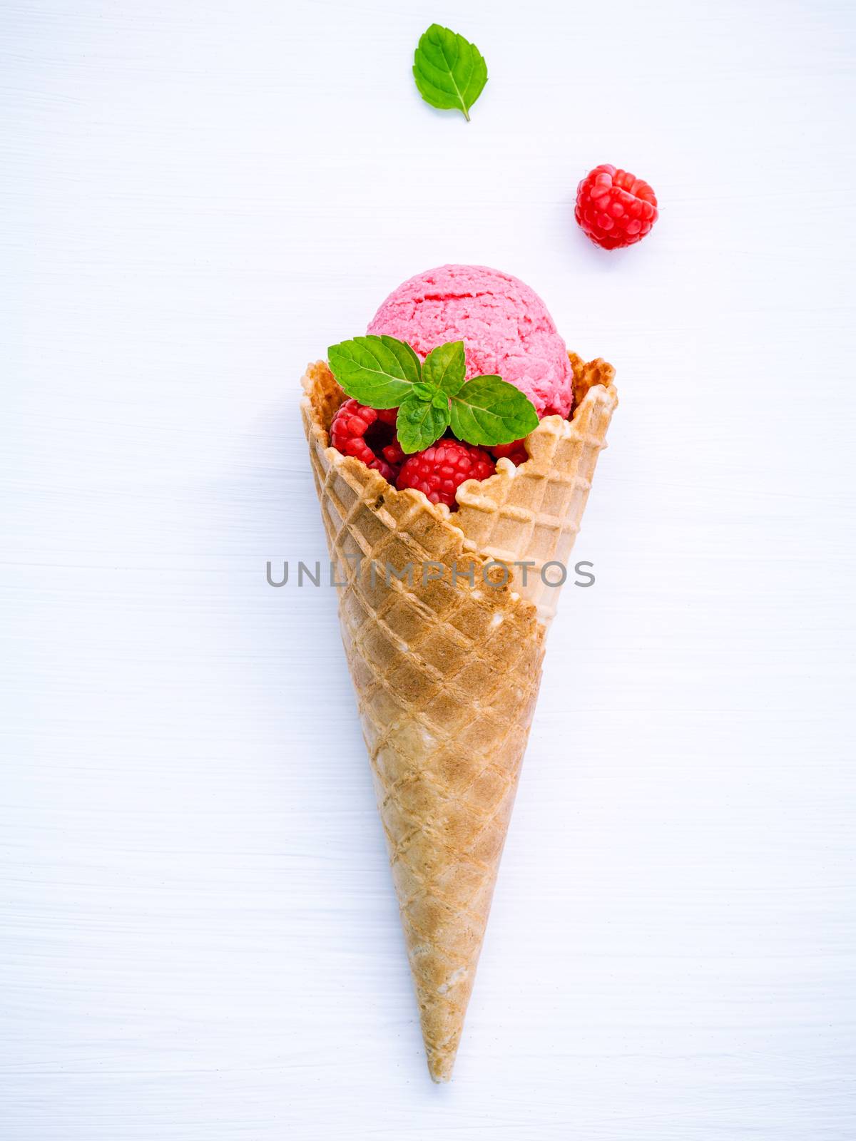 Raspberry ice cream in cone with fresh raspberry and peppermint  by kerdkanno