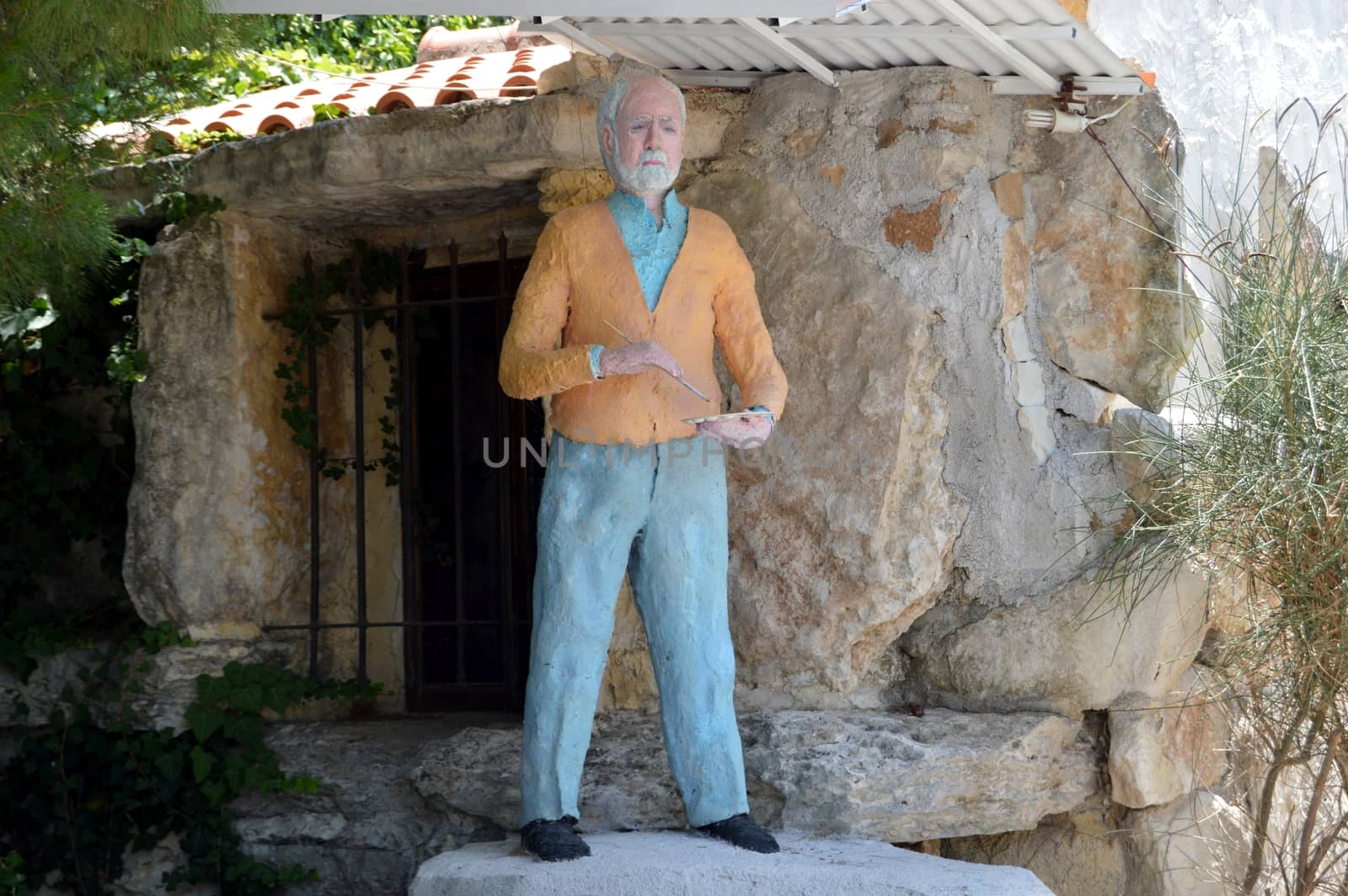 Paper statue to chew of an old painter outside.