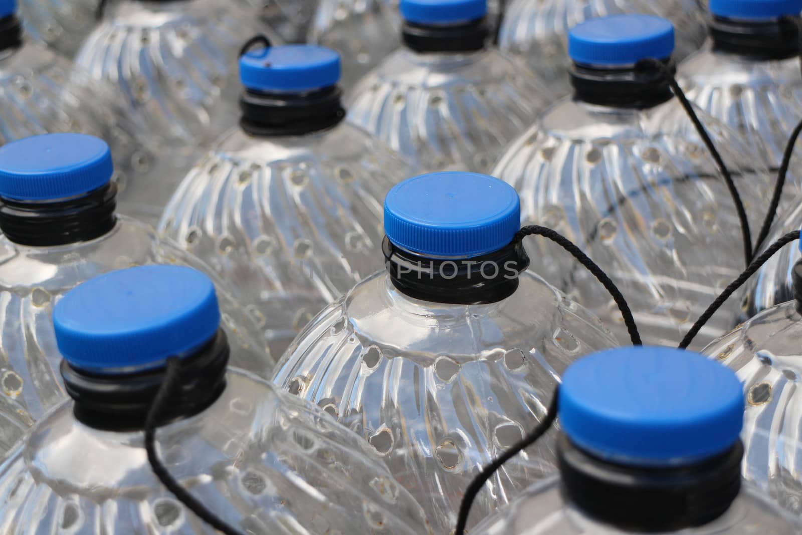 Water bottles with blue cups close to  