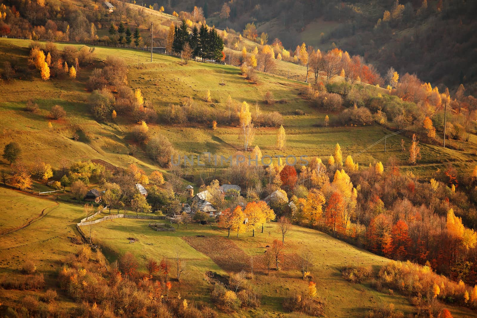 Fall in mountain village. Alpine October scene.