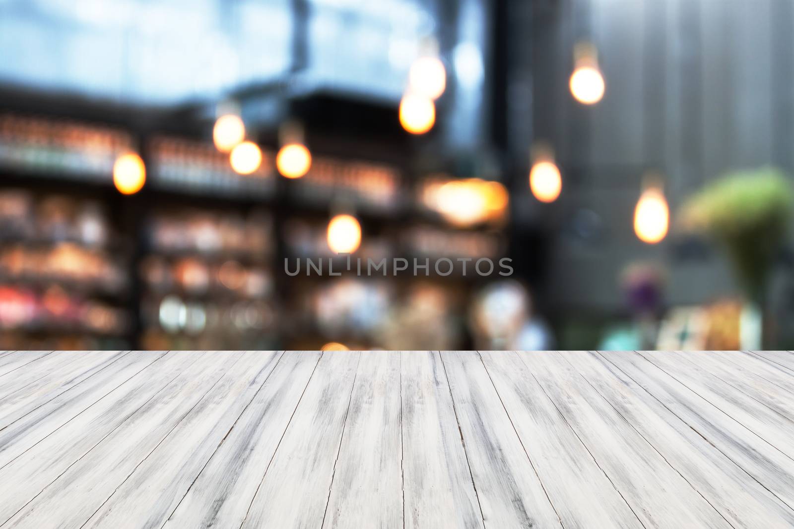 White luxury top wooden with blurred cafe background by punsayaporn