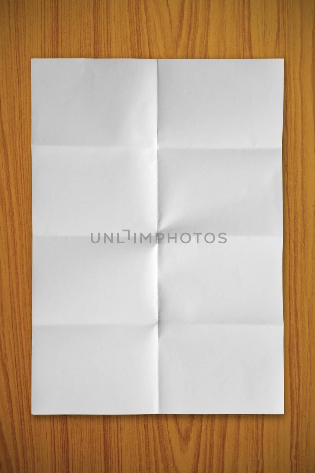Blank white paper on a wooden background