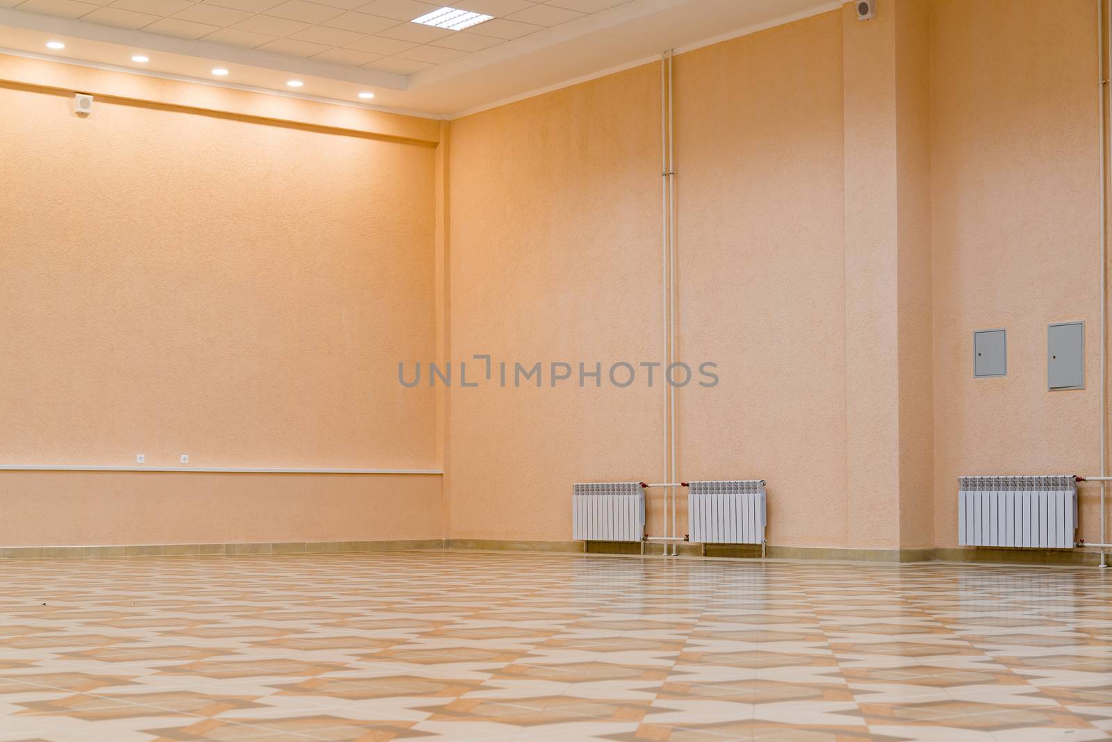 White new radiator on a pink wall