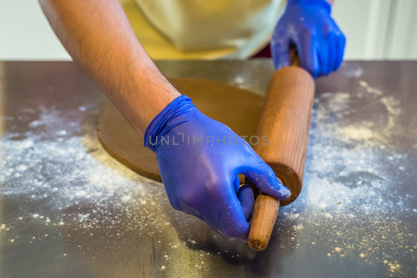 hand rolled out dough with gloves by okskukuruza