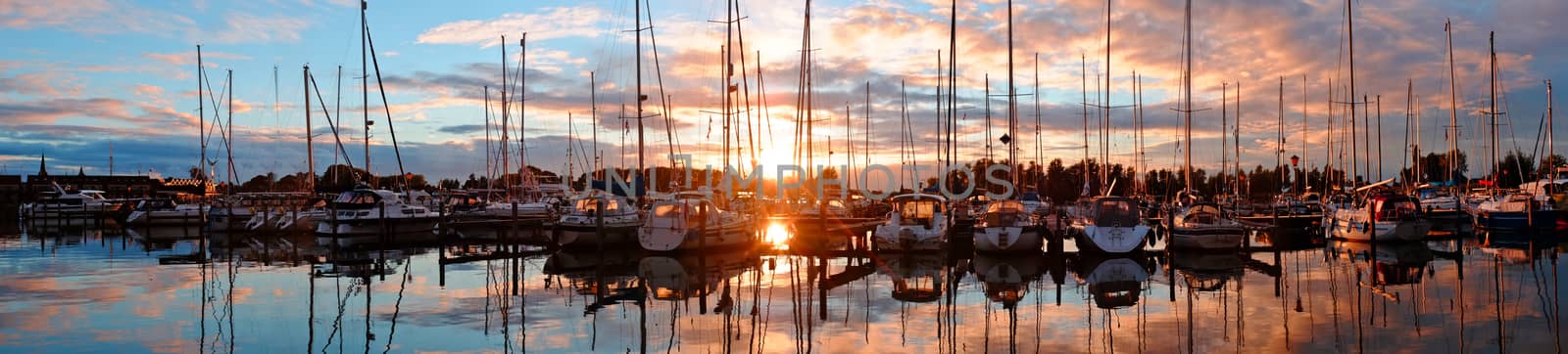 Panorama from boats in the harbor from Katwoude in the Netherlands at sunset