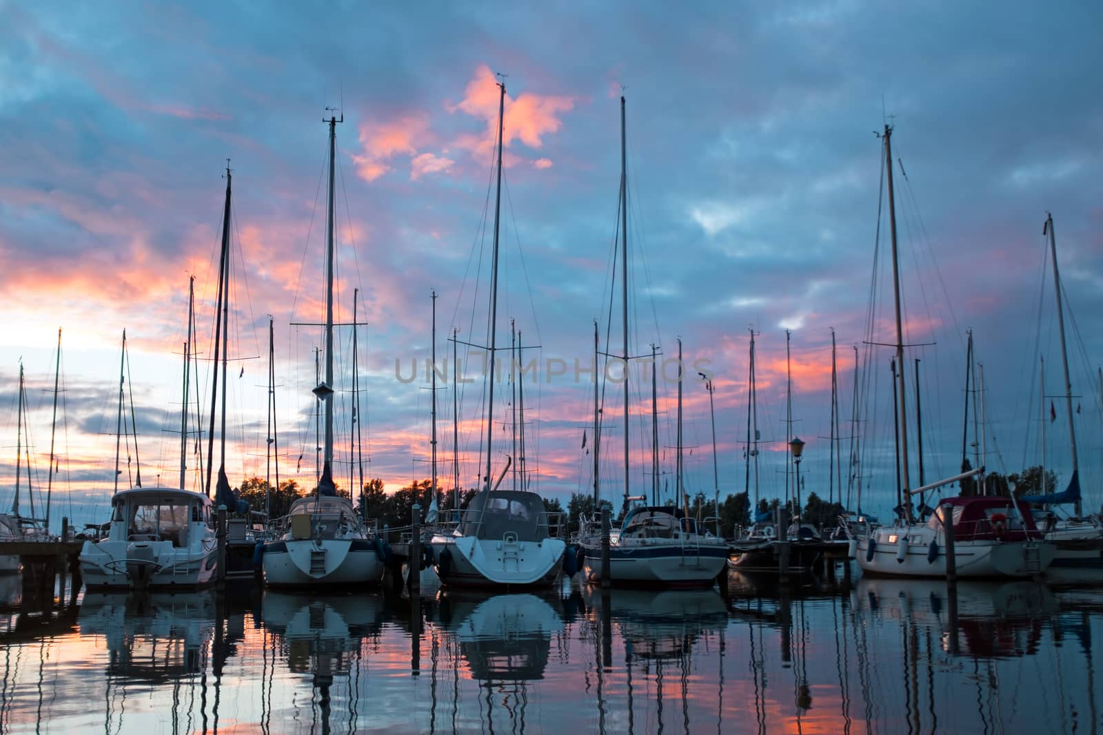 Boats in the harbor from Katwoude in the Netherlands at sunset