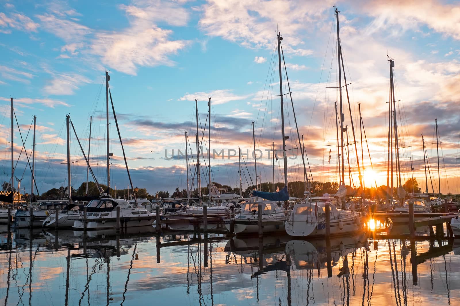 Boats in the harbor from Katwoude in the Netherlands at sunset