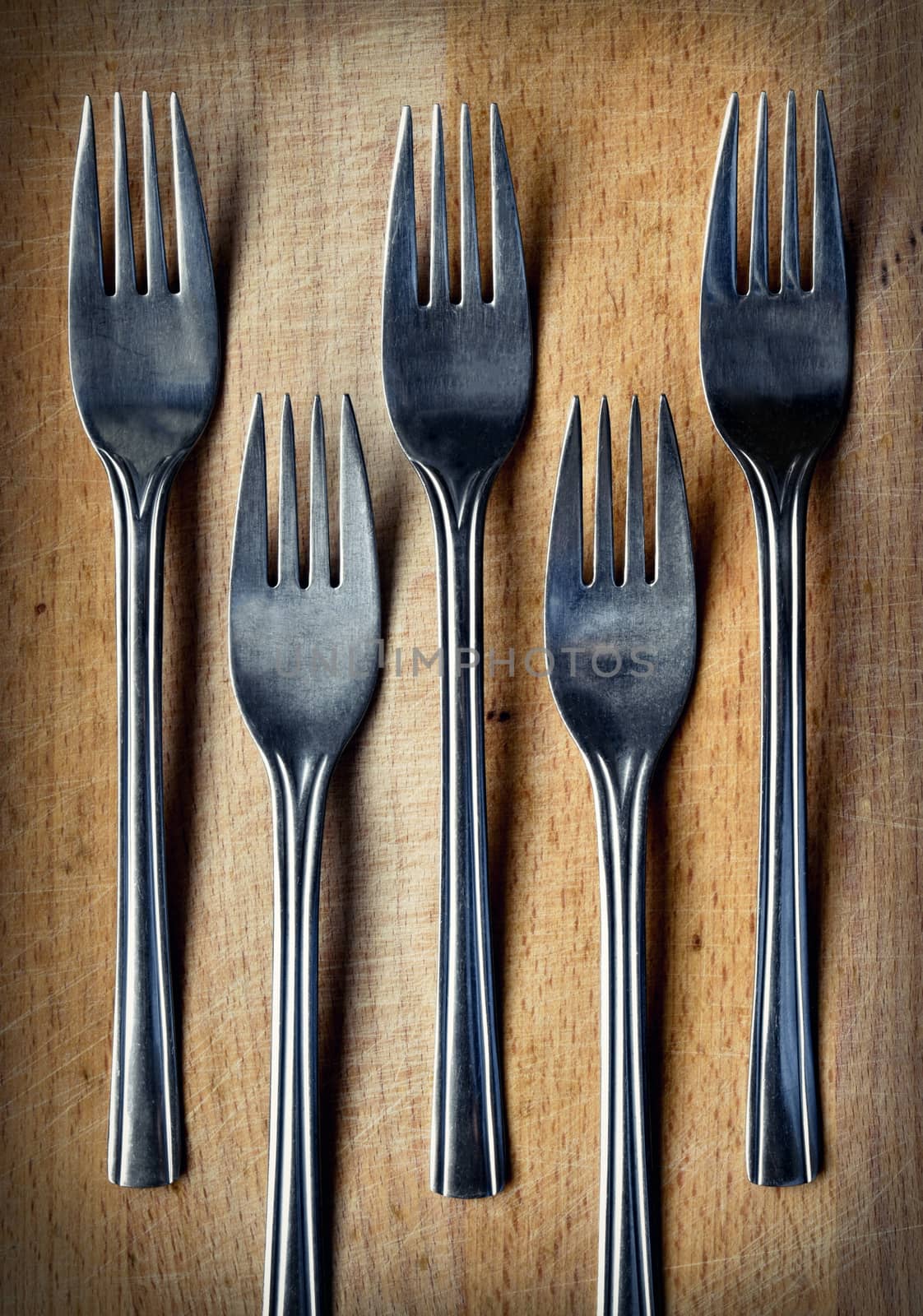 forks on a wooden kitchen board by Ahojdoma