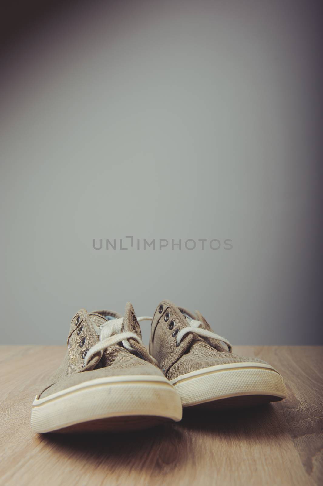 Blue lovely used sneakers on wooden desk