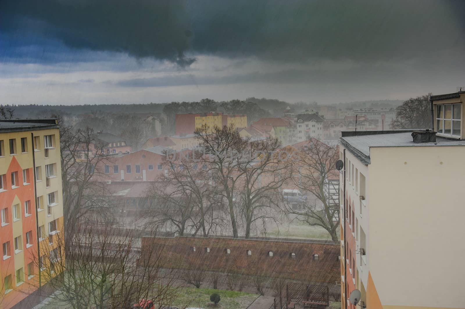 Heavy rain in the city with dramatic dark clouds