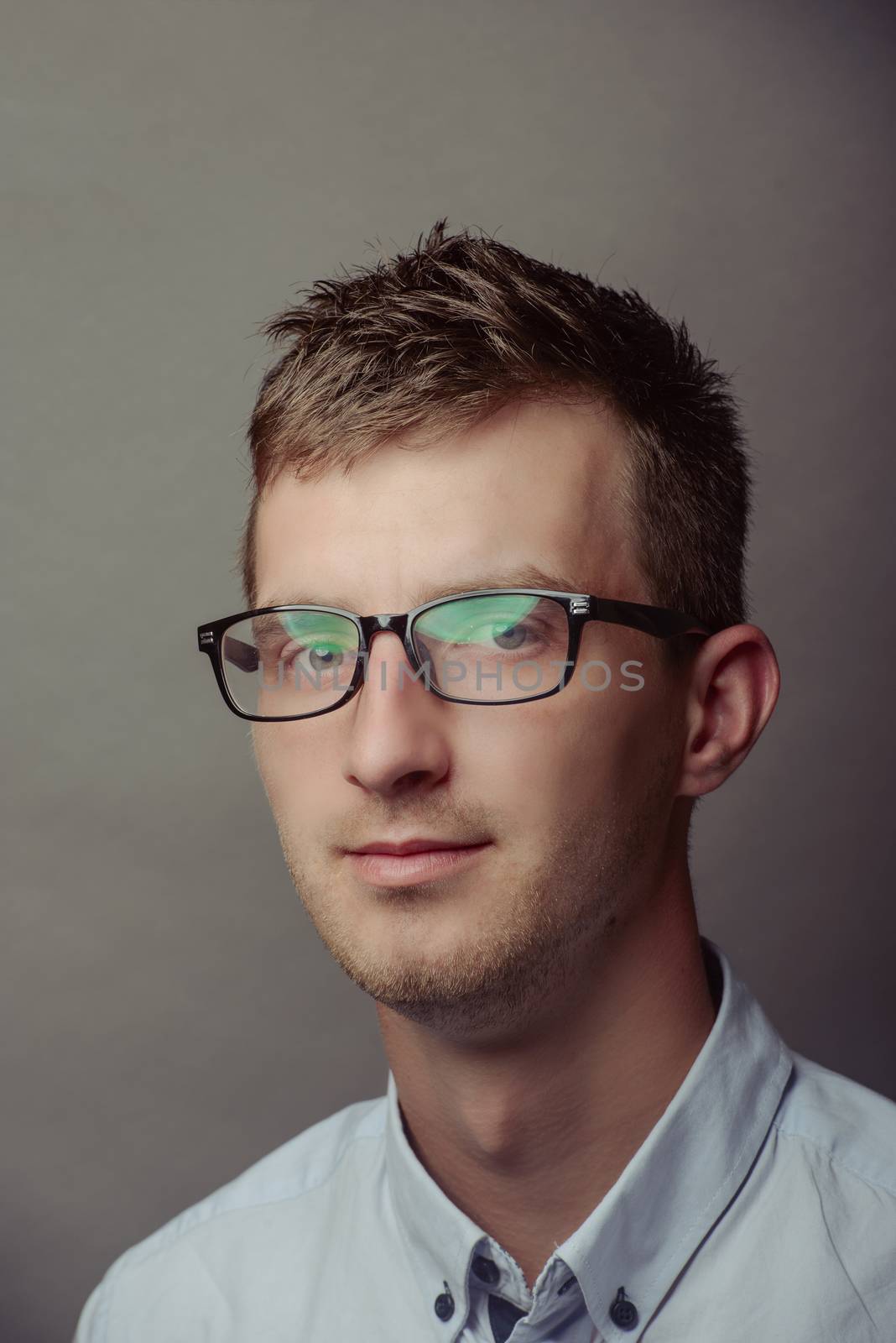 Portrait of a smart serious young man.