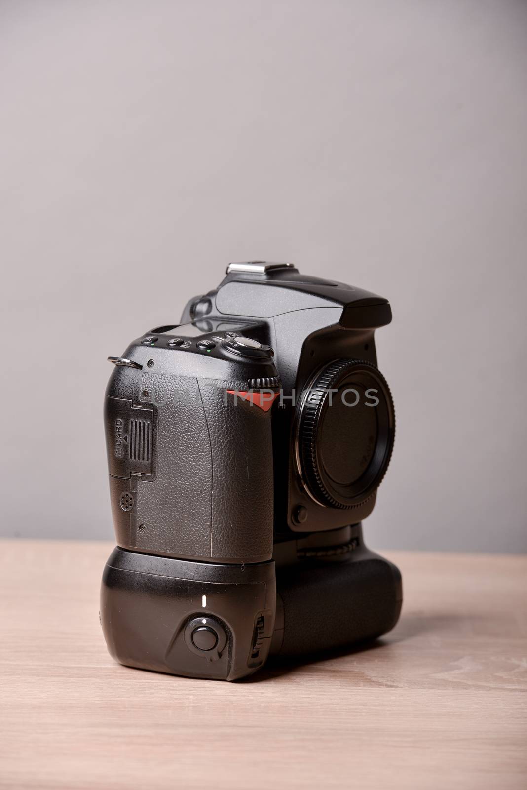 Digital photo camera on wooden desk table