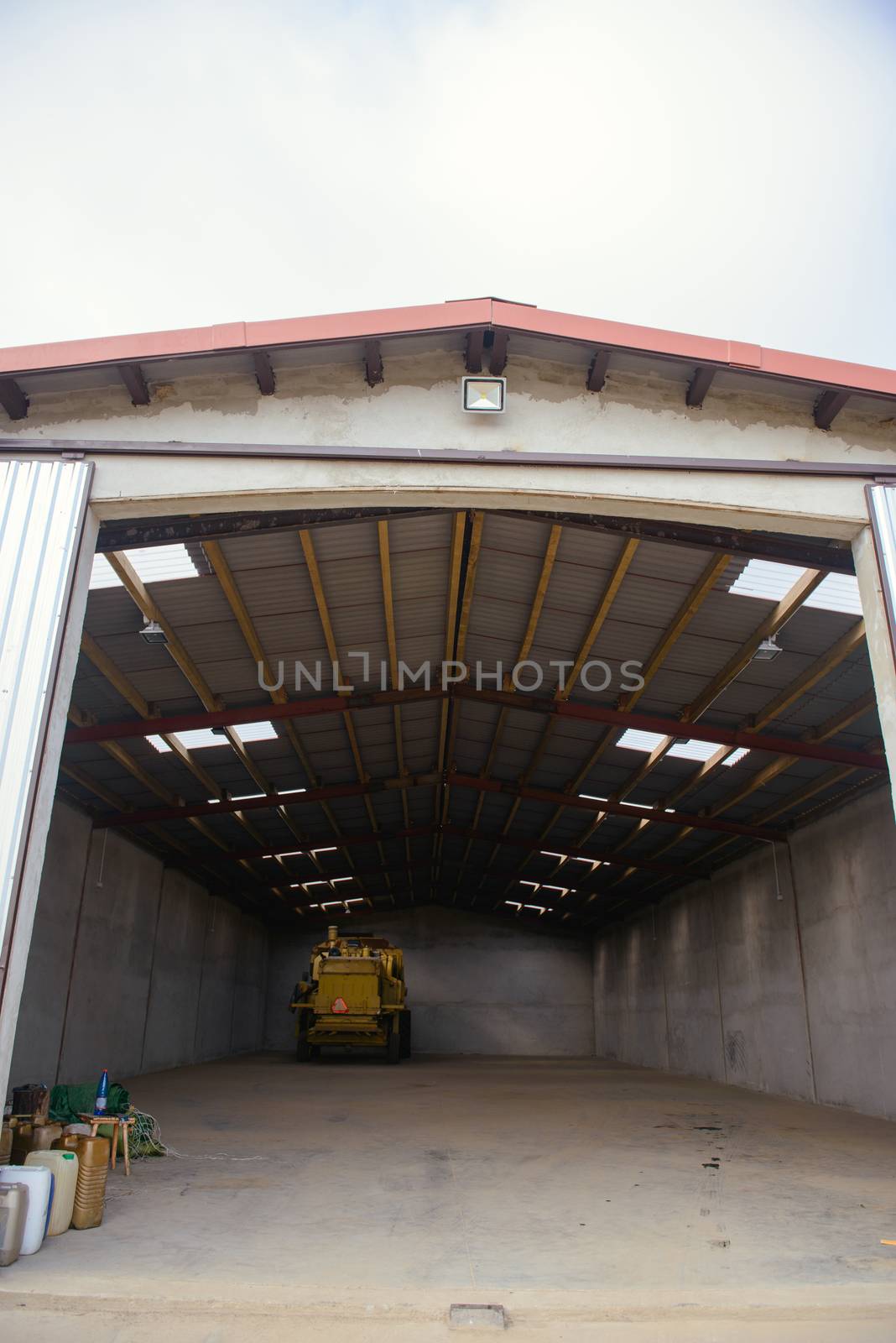 combine harvester standing ready for harvest in a warehouse