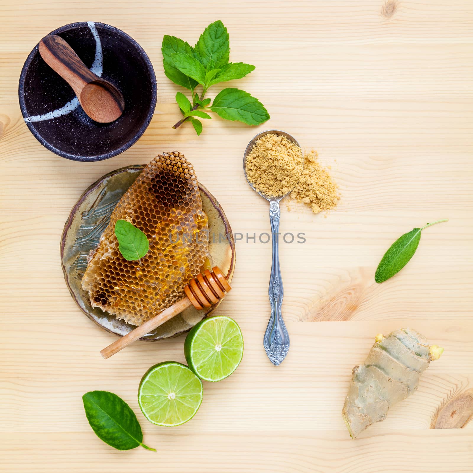 Honeycomb in wooden bowl with herbs mint ,thyme and sage set up  by kerdkanno