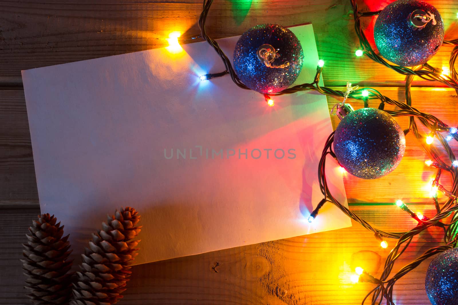 garland and Christmas tree branches on wooden tab by liwei12