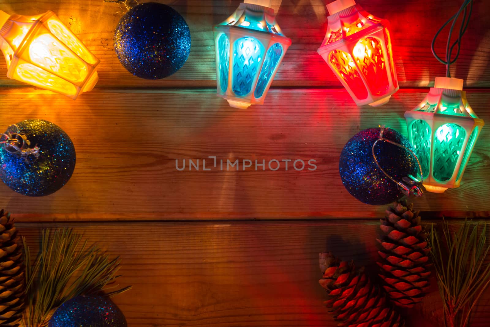 garland and Christmas tree branches on wooden table mock up