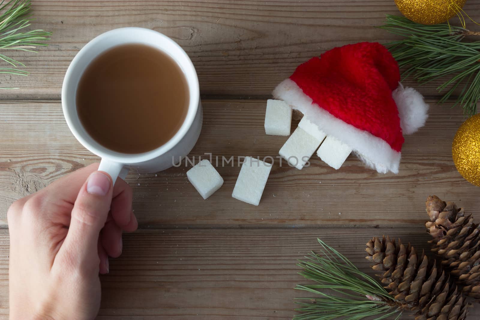 cup of coffee and sugar in Santa Claus cap on wooden table