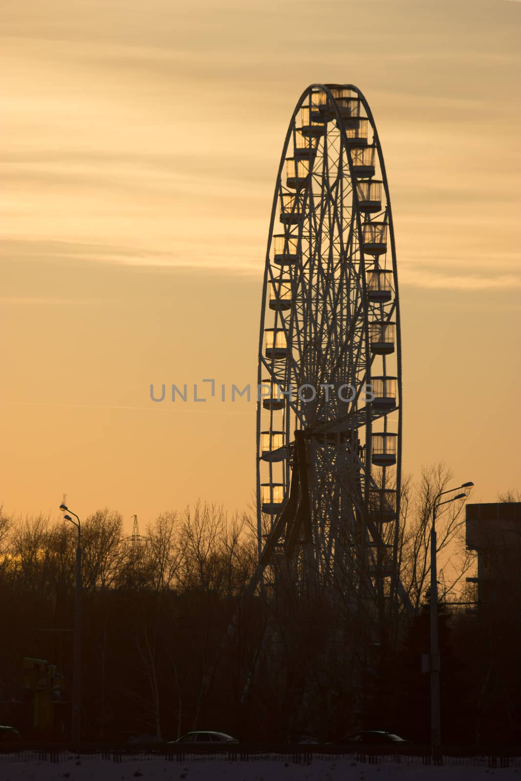 Silhouette of old ferris wheel at sunset in winter