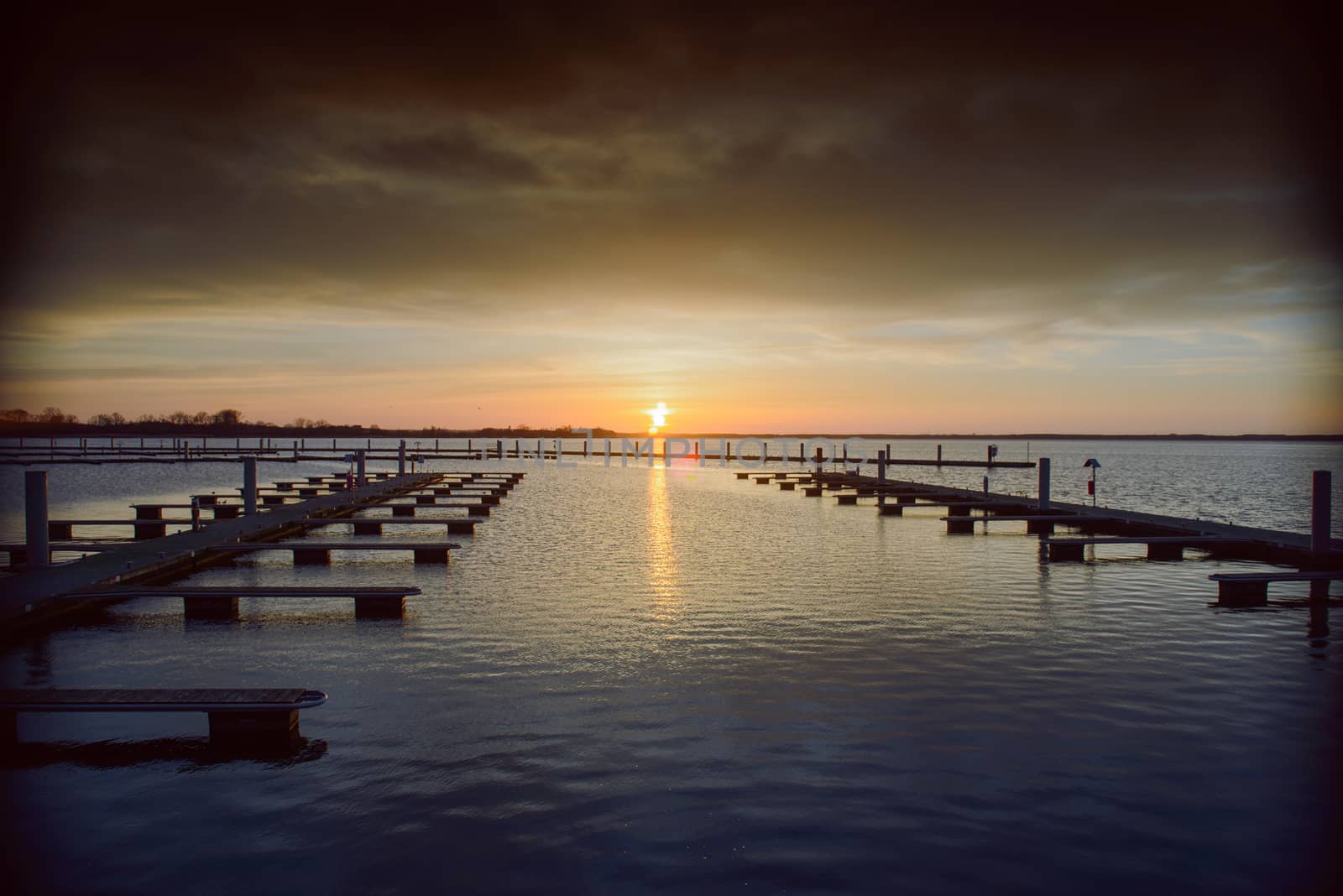 Yacht port over beautiful orange sunset in summer time
