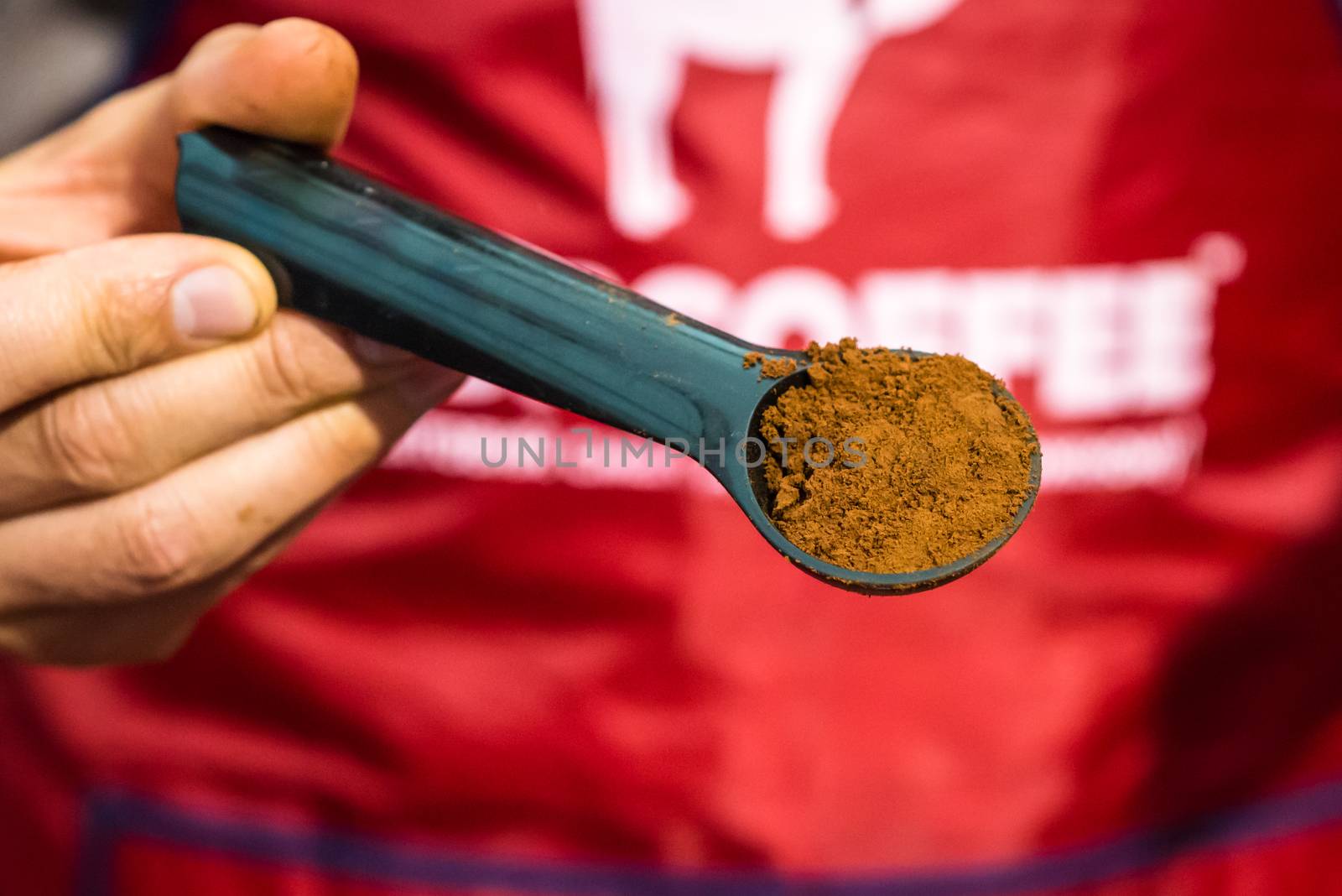 hand holding a coffee on spoon by okskukuruza