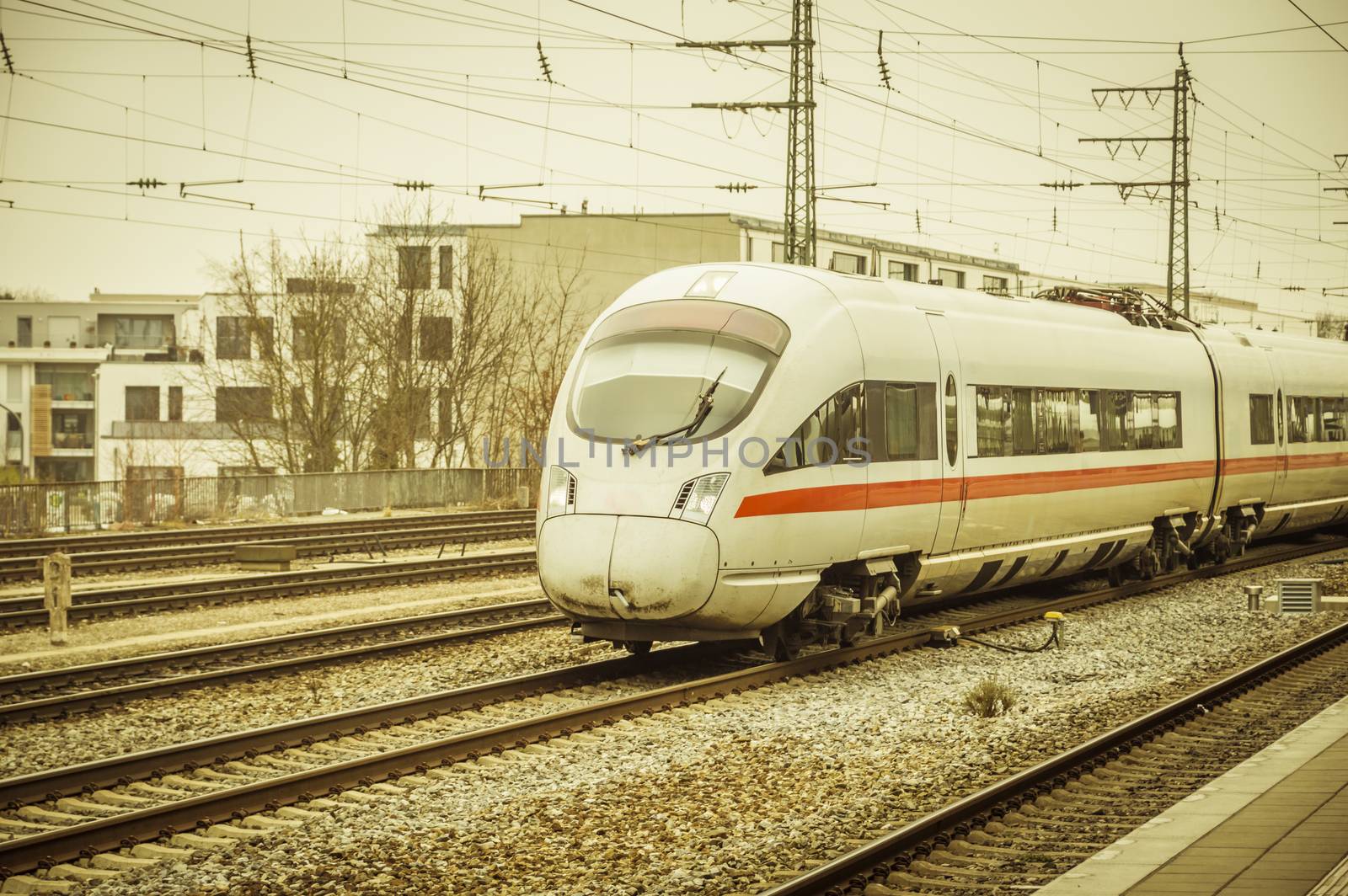 Image with a gray  intercity train, modern and high speed public transportation, arriving in the station