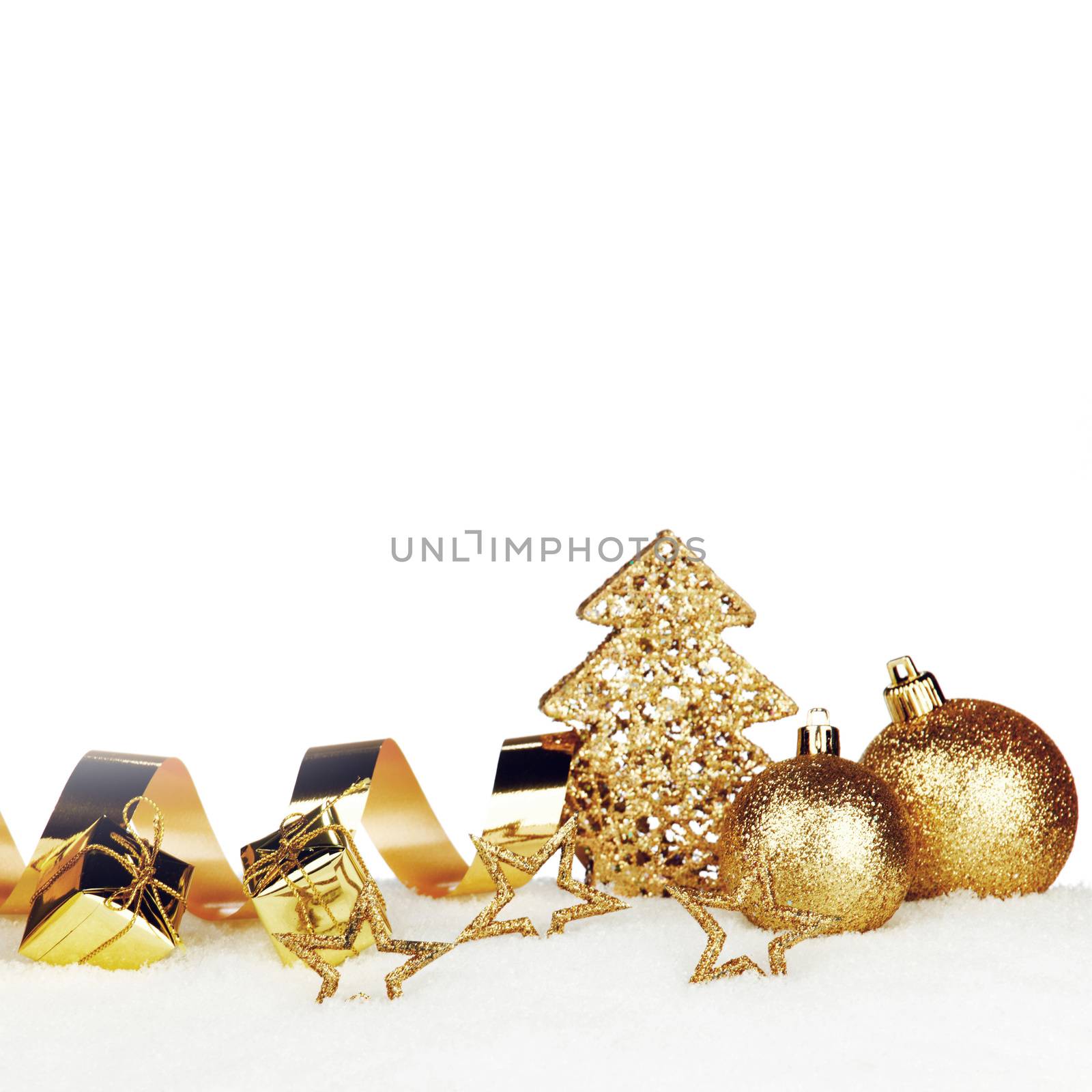 Beautiful various golden christmas decor on snow close-up