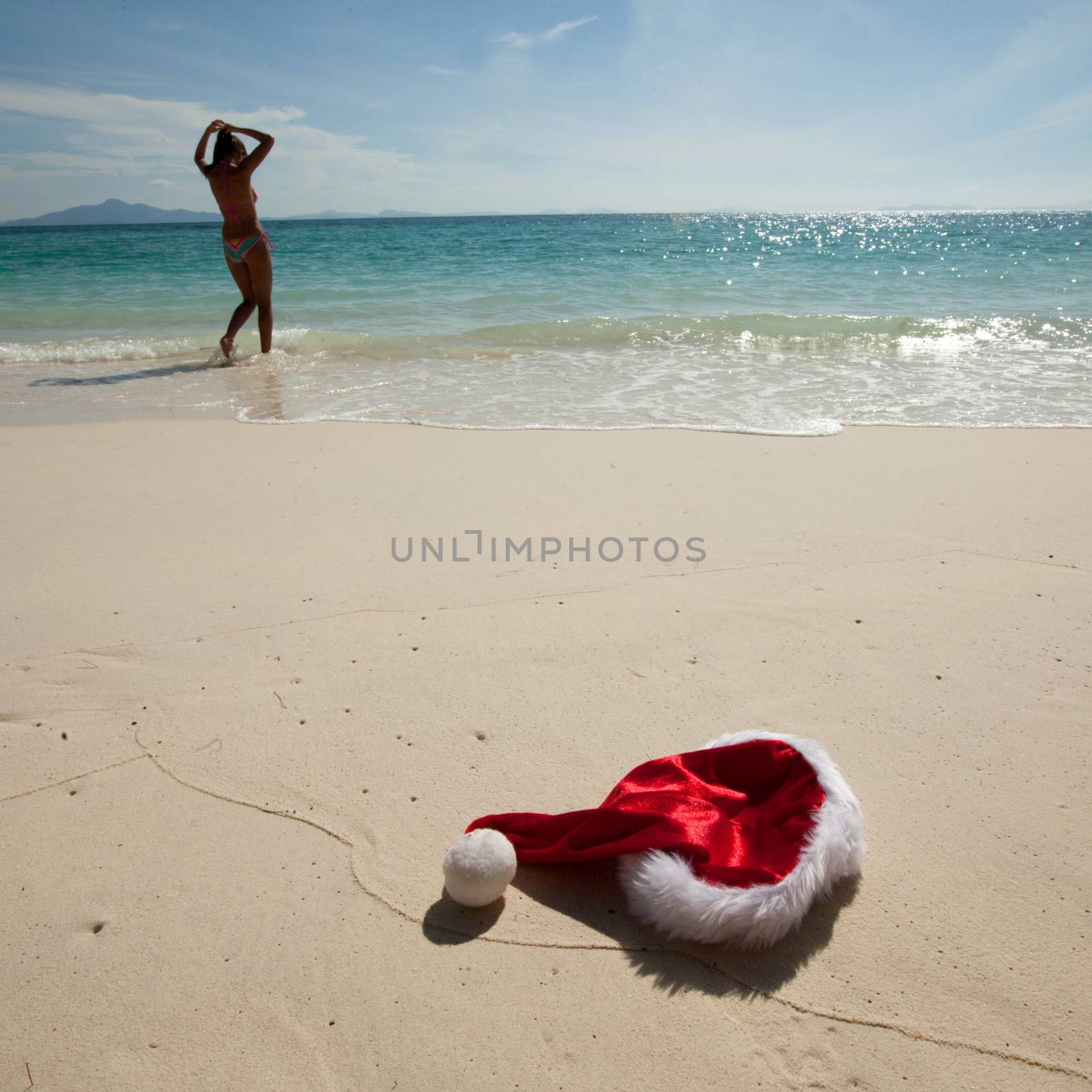 Christmas hat on beach by Yellowj