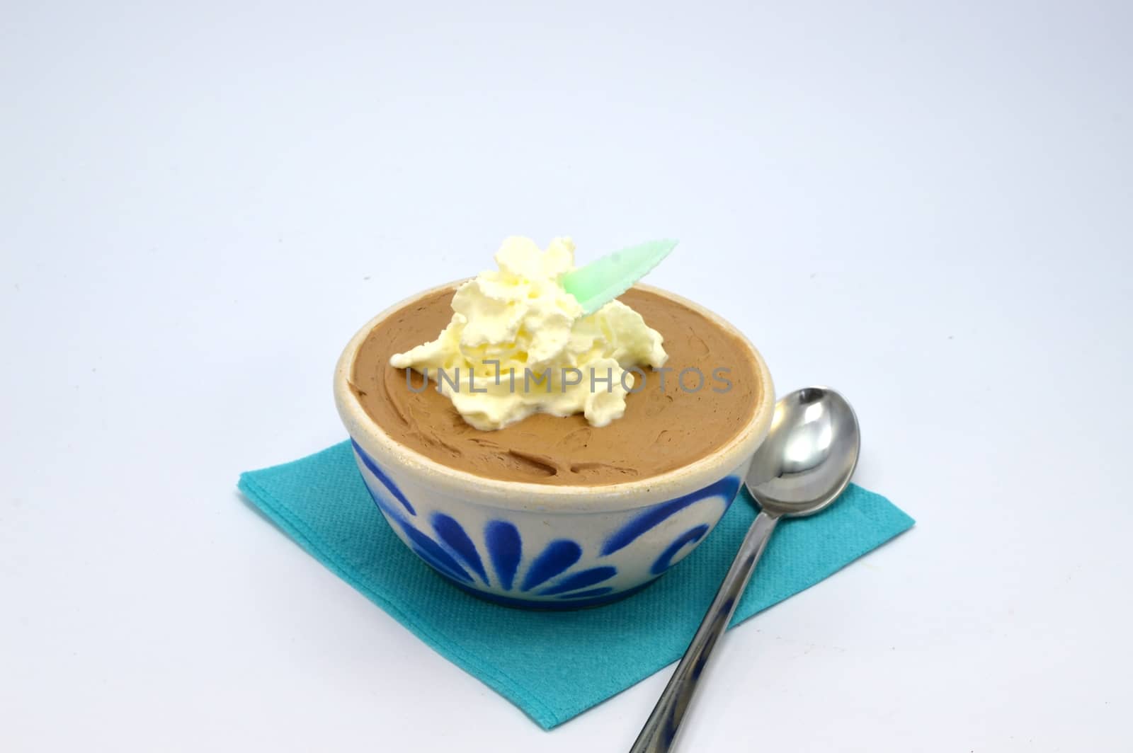 A dark chocolate mousse in a ramekin porcelain on a blue towel