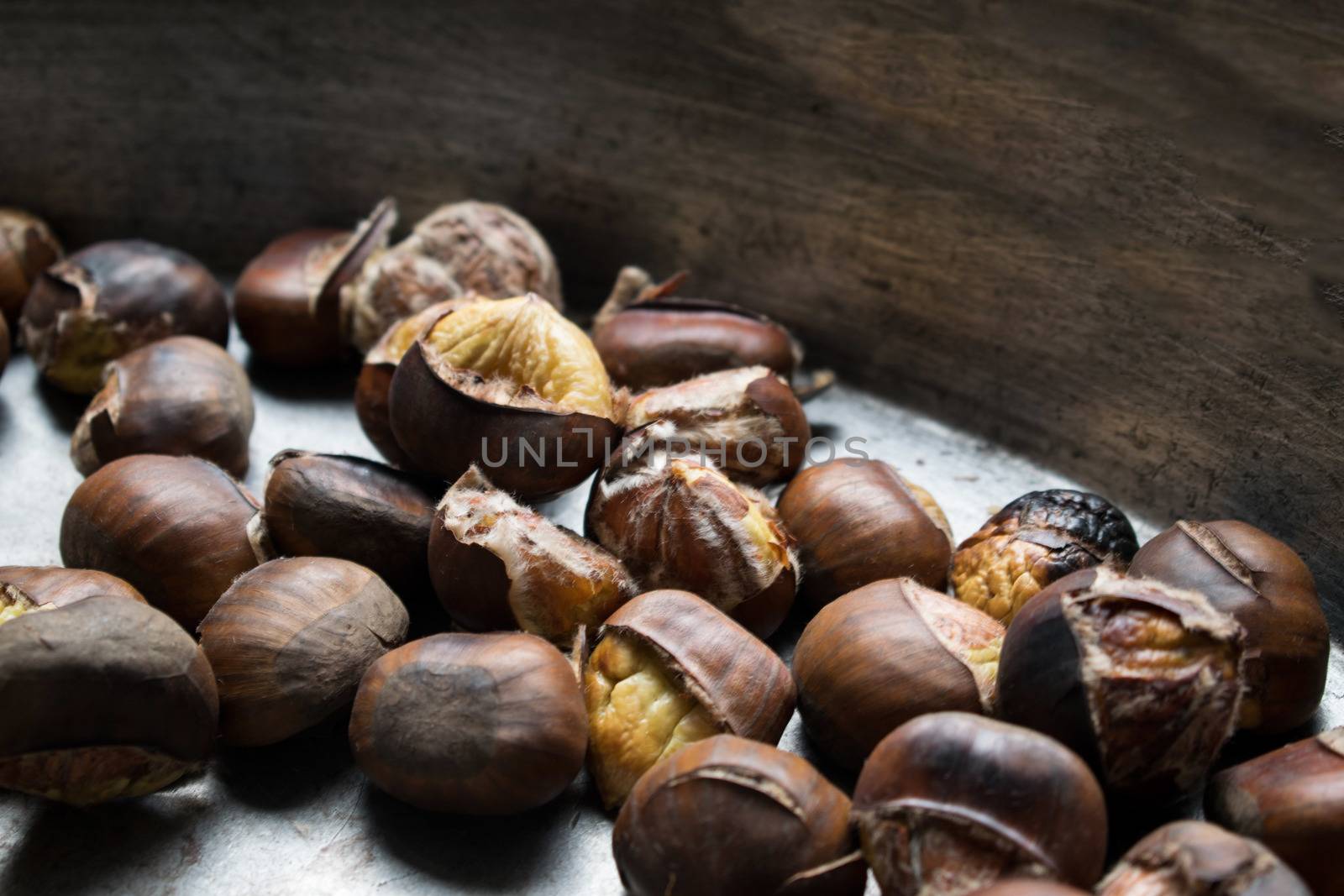 Background of roasted chestnuts seasonal street food