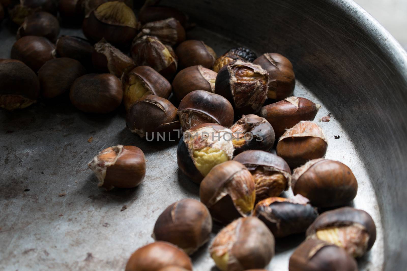 Background of roasted chestnuts seasonal street food