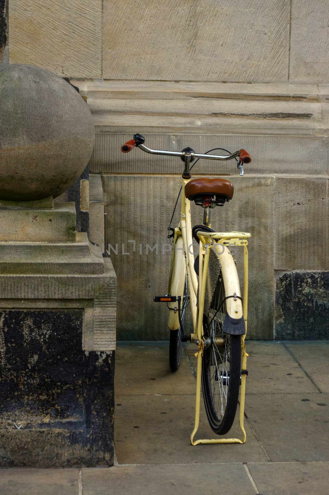 old yellow bicycle. leather seat with shock absorbers and wheel by evolutionnow