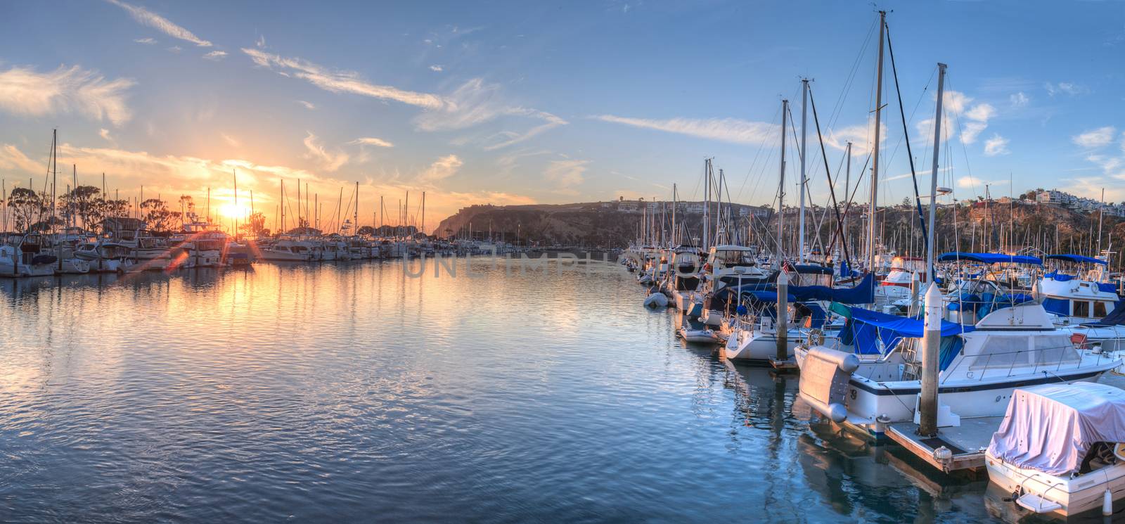 Sunset over sailboats in Dana Point harbor by steffstarr