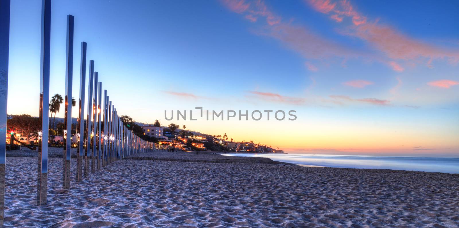 Sunrise over mirrored posts at Main Beach by steffstarr