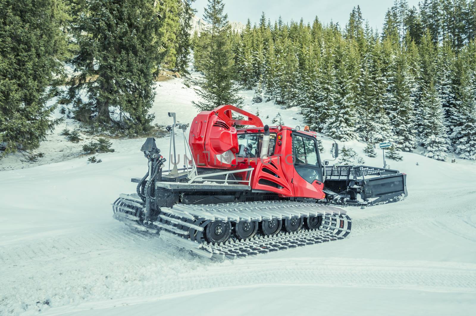 Winter image with a modern snow groomer machine, captured in the Austrian Alps, near the village Ehrwald, district Reutte in Tirol