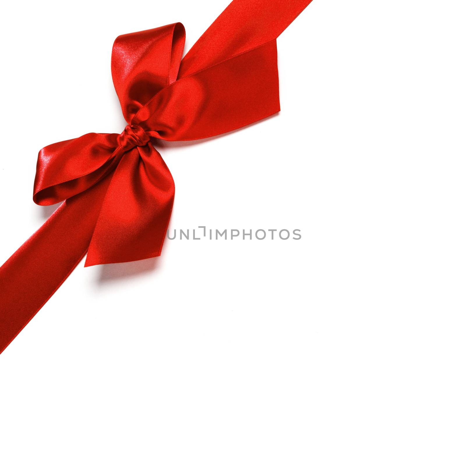 Red satin bow ribbon on white by Yellowj
