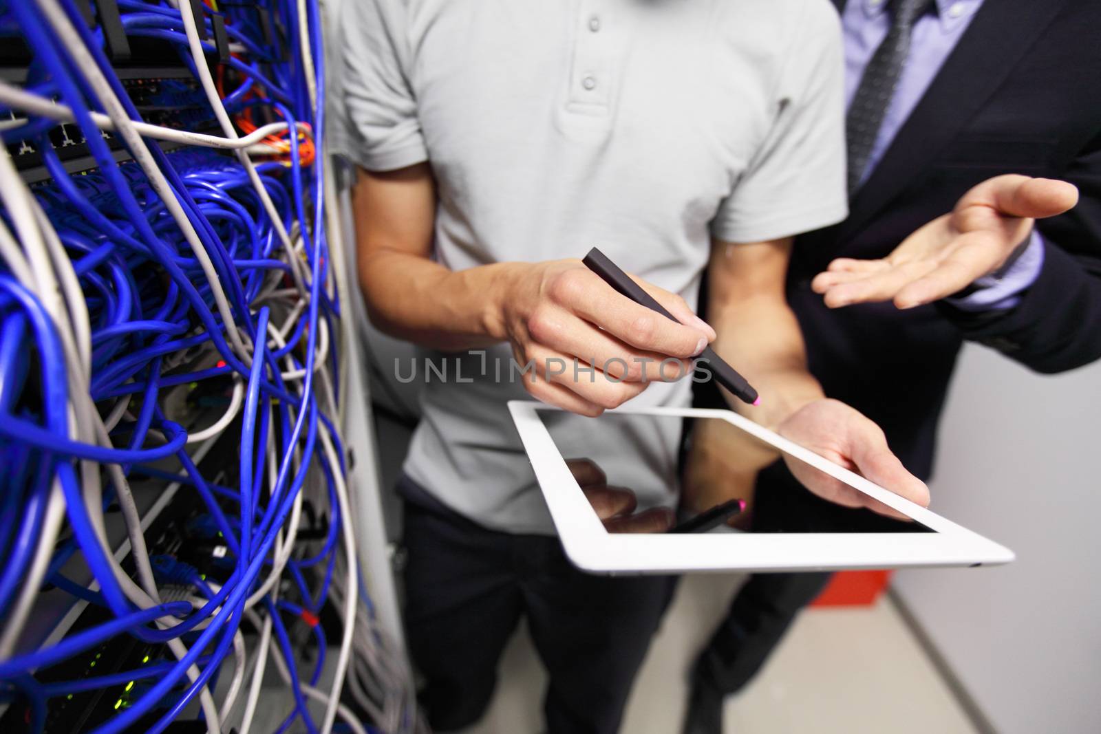 Men with tablet in service room by ALotOfPeople