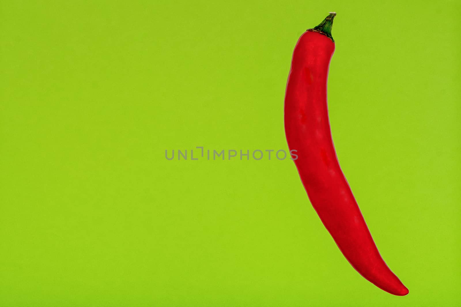 Red Chilli isolated on a green background