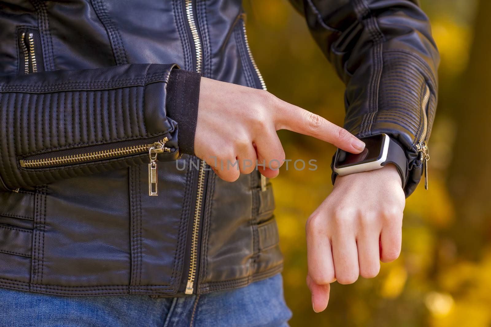 Young girl wears smart watch with touchscreen. Focus on watch!