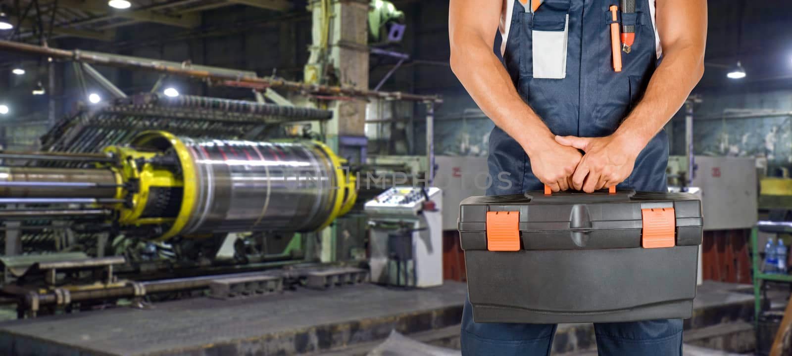 Worker with instruments at industrial factory