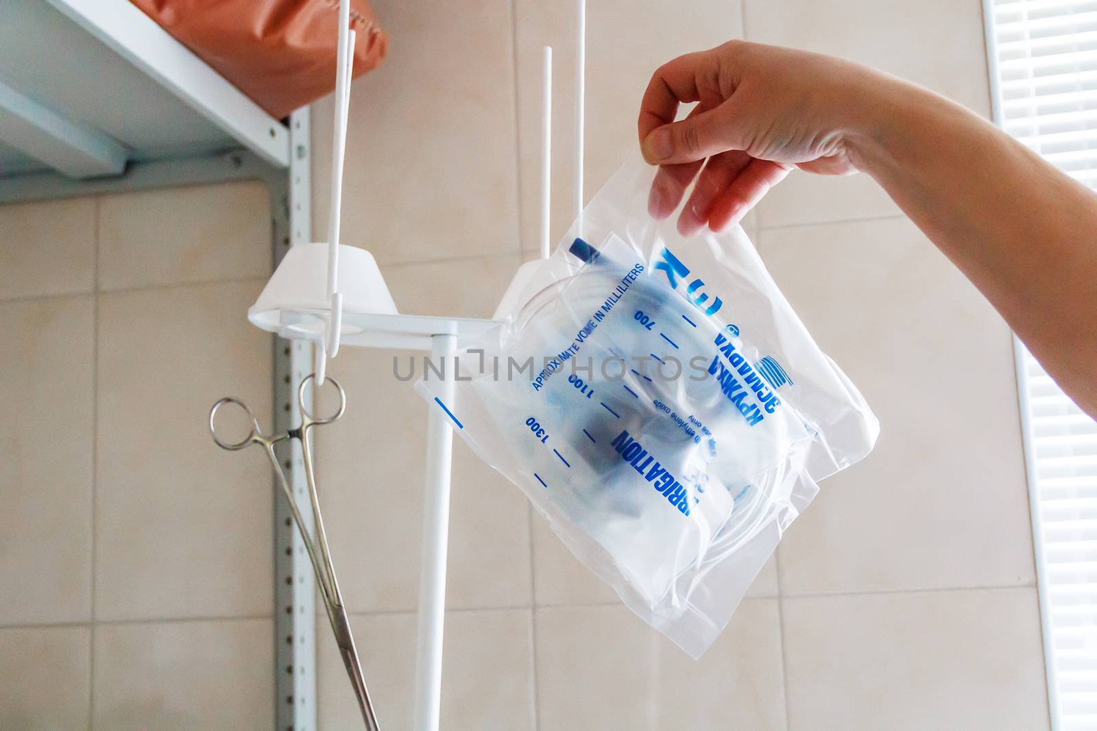 Photo of hand holding drop counter in a bag
