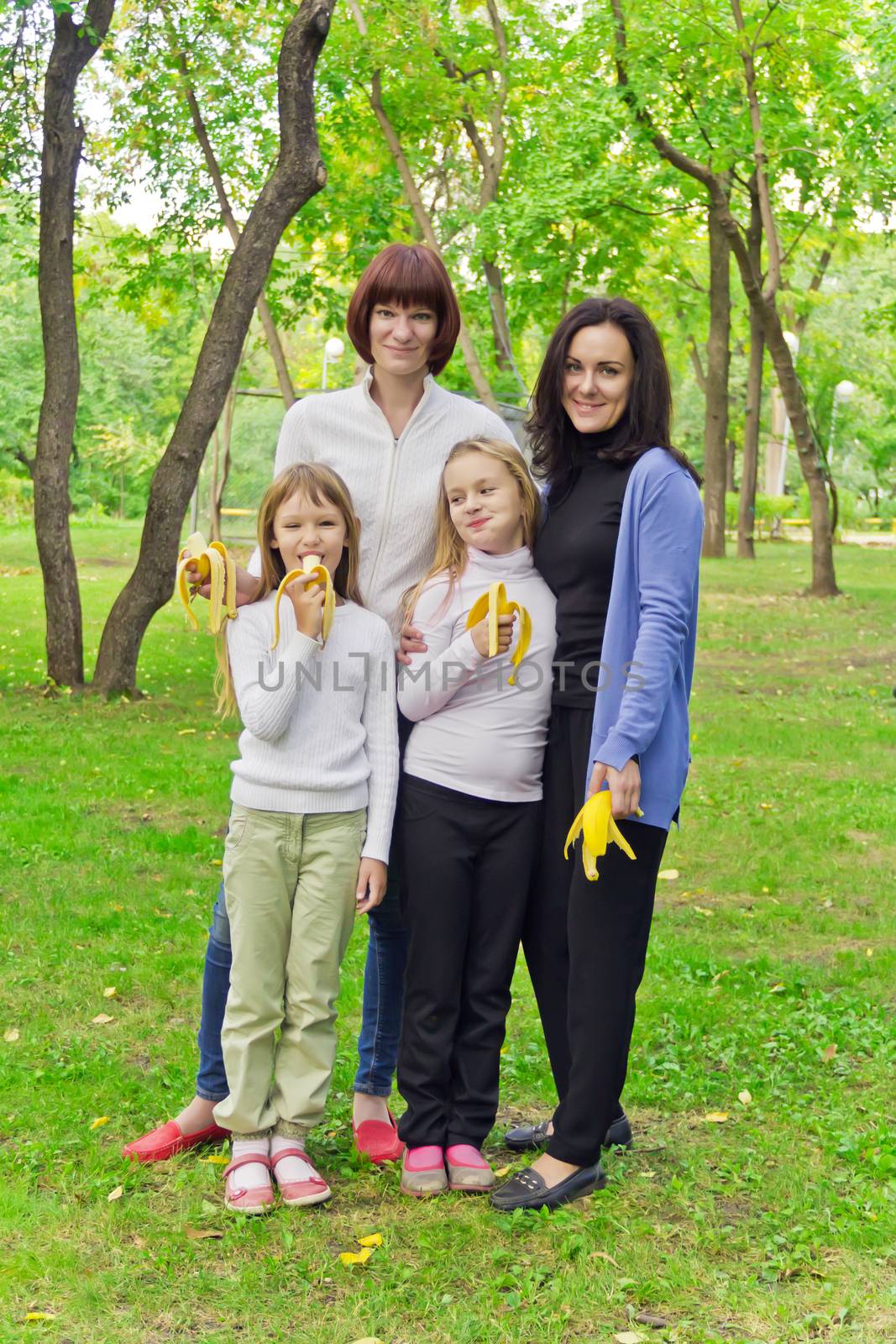 Photo of group people are eating bananas