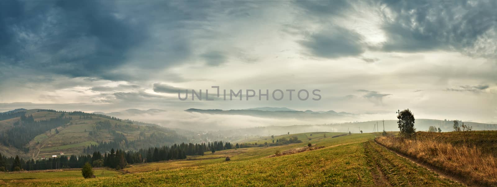 Cloudy morning in mountains. Autumn village on hillsides. by weise_maxim