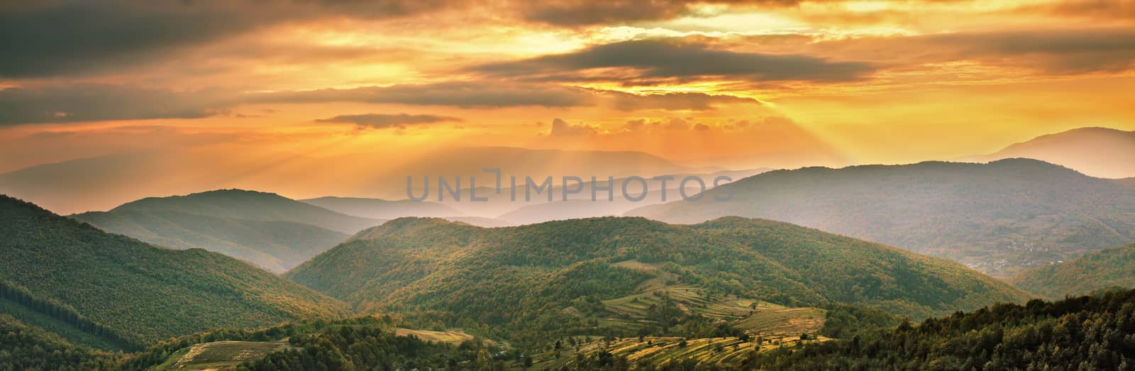 Colorful mountain sunset panorama. Autumn alpine village scene