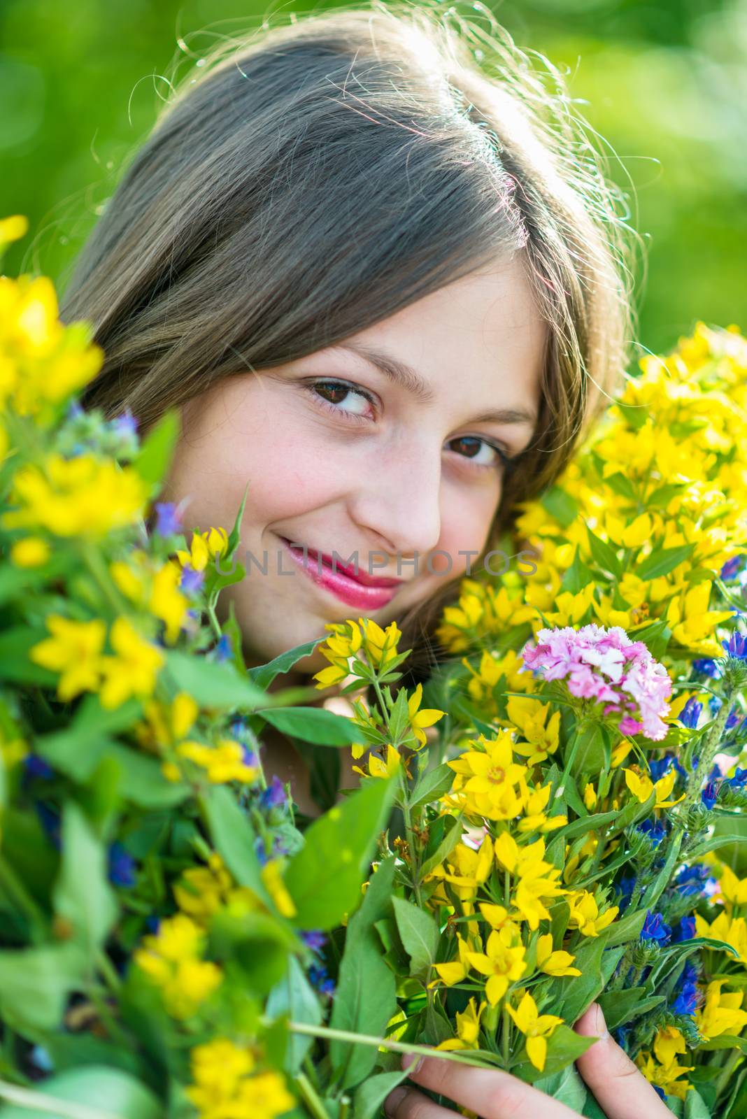 Portrait of a girl with flowers in the garden